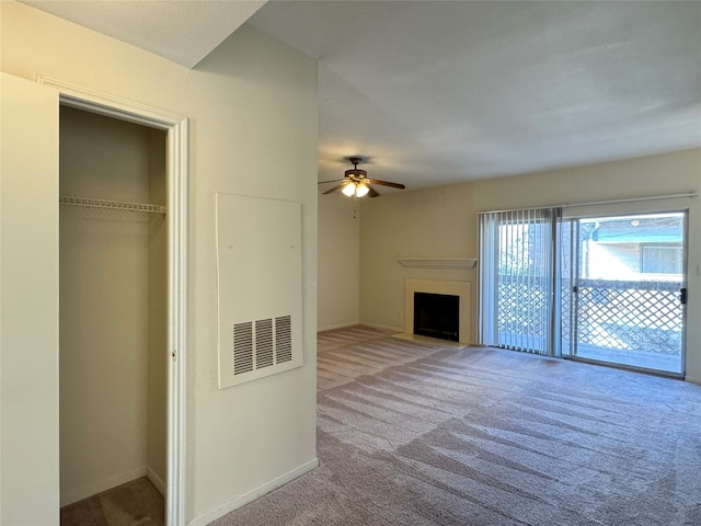 unfurnished living room with light colored carpet and ceiling fan