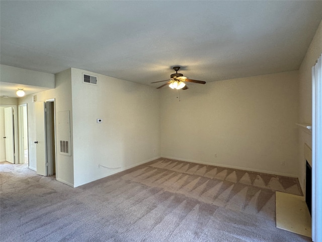 unfurnished living room featuring ceiling fan and light colored carpet