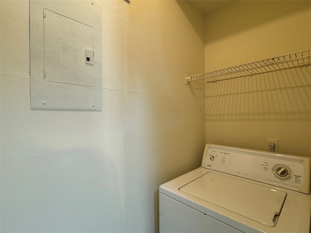 clothes washing area featuring electric panel and washer / clothes dryer