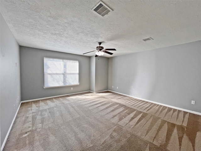 carpeted empty room featuring a textured ceiling and ceiling fan