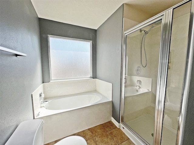 bathroom featuring tile patterned flooring, shower with separate bathtub, and toilet