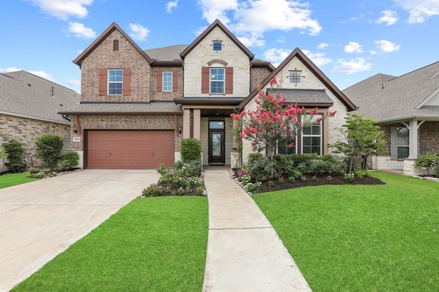 view of front facade featuring a front yard and a garage