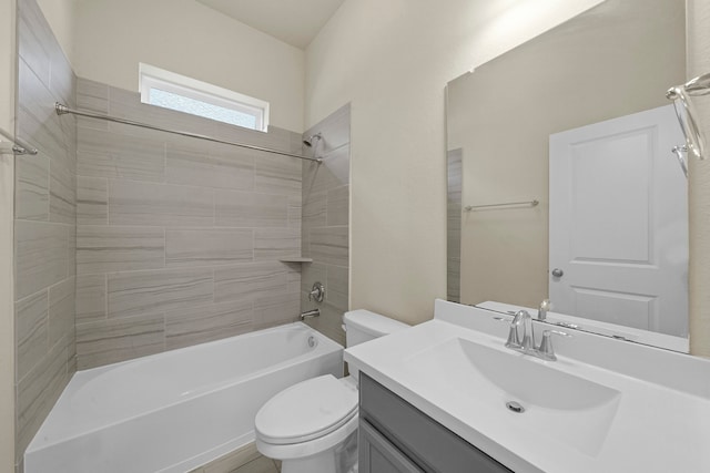 full bathroom with tiled shower / bath, vanity, and toilet