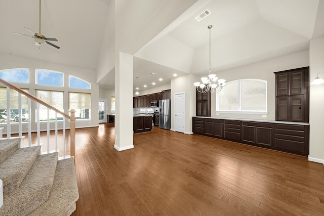 kitchen with dark hardwood / wood-style floors, high vaulted ceiling, stainless steel appliances, and a wealth of natural light