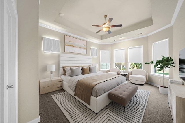 bedroom featuring ceiling fan, a raised ceiling, ornamental molding, and carpet floors