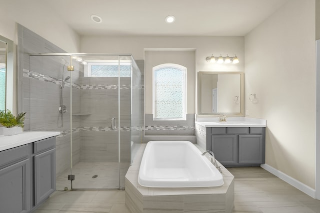 bathroom featuring vanity and shower with separate bathtub