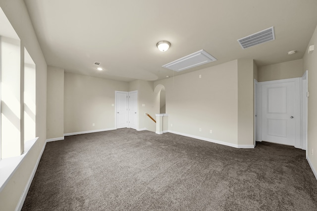 spare room featuring dark carpet