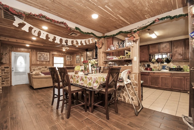 dining area featuring sink, wood ceiling, and light hardwood / wood-style floors