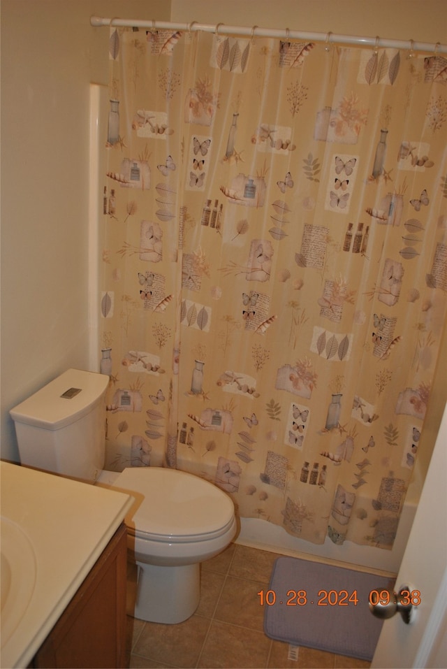 bathroom featuring vanity, a shower with curtain, toilet, and tile patterned floors