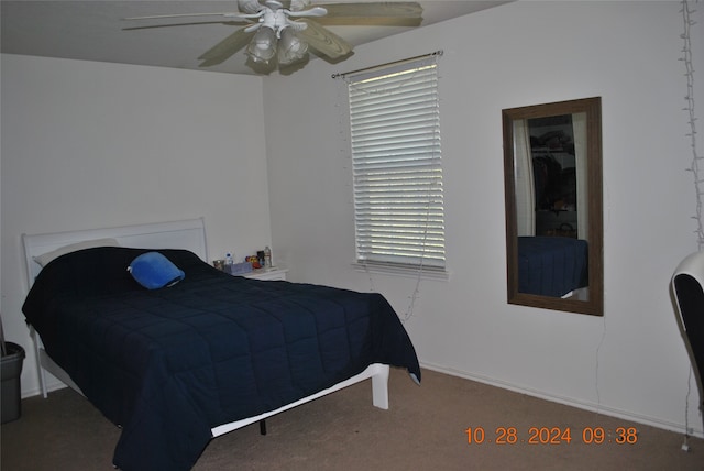 bedroom featuring dark carpet and ceiling fan