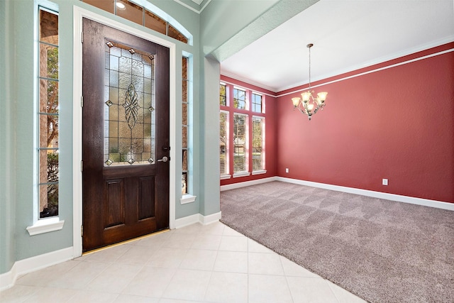 carpeted entryway with crown molding and a notable chandelier