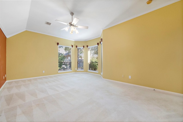 carpeted spare room featuring vaulted ceiling, ceiling fan, and ornamental molding