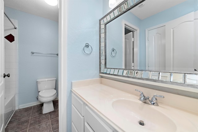 full bathroom with vanity, tile patterned floors, washtub / shower combination, toilet, and a textured ceiling