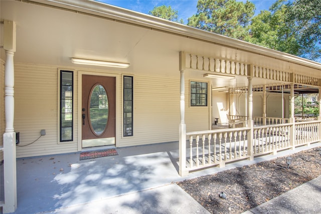 doorway to property featuring covered porch