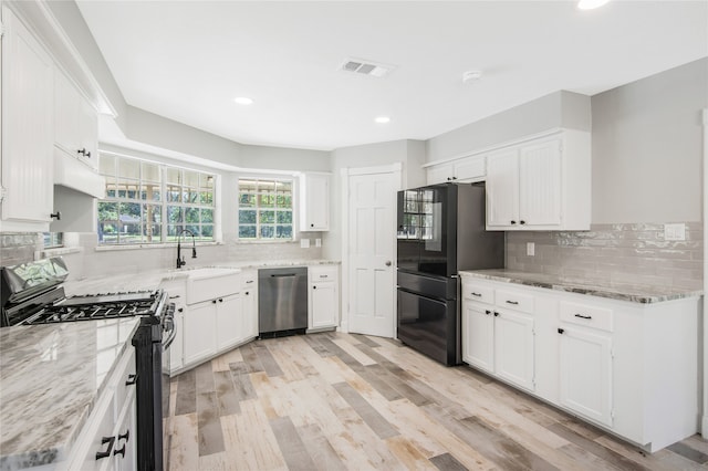 kitchen featuring white cabinetry, stainless steel appliances, and sink