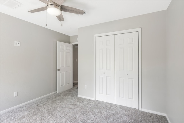 unfurnished bedroom featuring a closet, light colored carpet, and ceiling fan