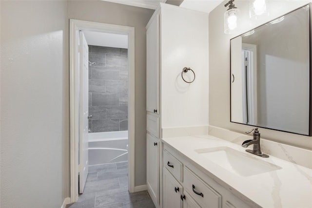 full bathroom featuring vanity, baseboards, and tub / shower combination
