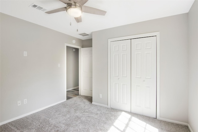 unfurnished bedroom with a ceiling fan, visible vents, carpet floors, baseboards, and a closet