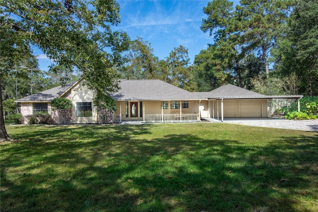 view of front of home featuring an attached garage, a front lawn, a porch, a carport, and gravel driveway