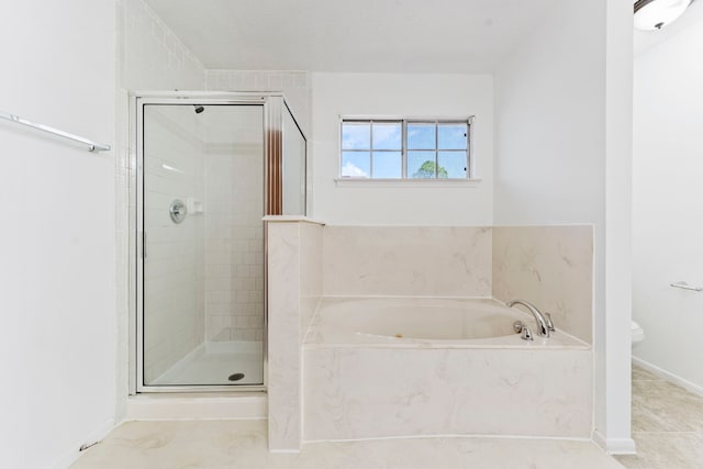 bathroom featuring tile patterned flooring, plus walk in shower, and toilet