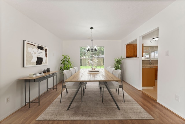 dining room featuring hardwood / wood-style floors and a chandelier