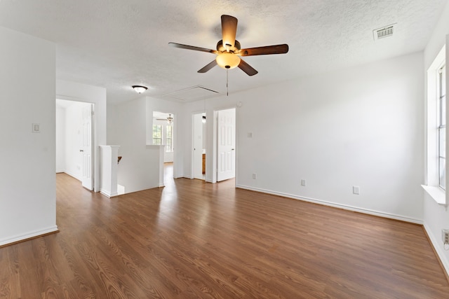 unfurnished living room with dark hardwood / wood-style floors and a textured ceiling