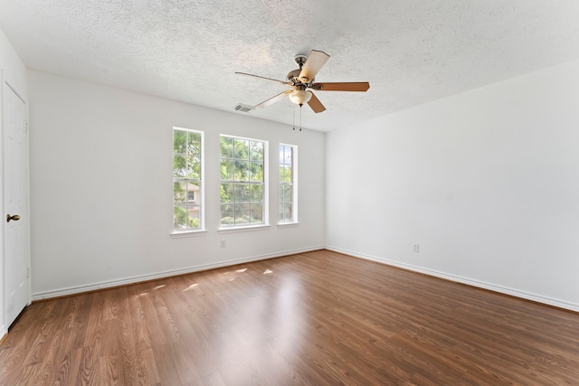 empty room with ceiling fan, hardwood / wood-style floors, and a textured ceiling