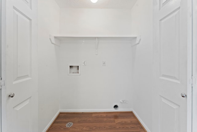 clothes washing area with electric dryer hookup, hookup for a washing machine, dark hardwood / wood-style flooring, and a textured ceiling