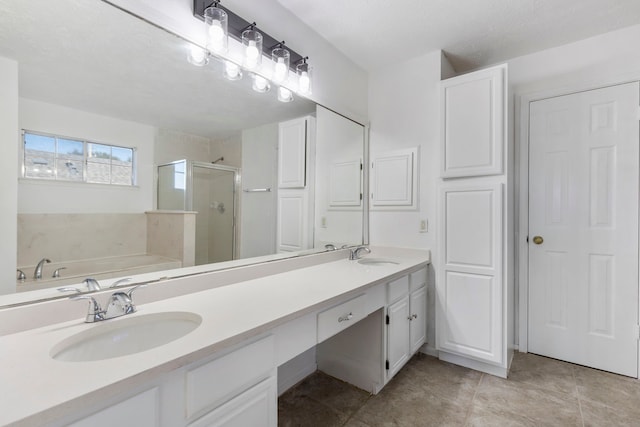 bathroom featuring shower with separate bathtub, vanity, and tile patterned floors