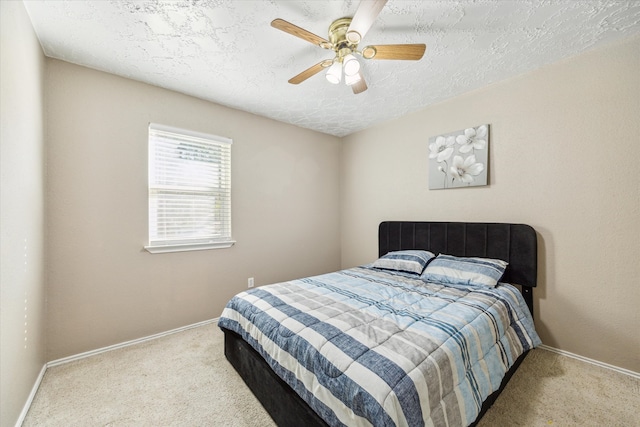 carpeted bedroom with a textured ceiling and ceiling fan