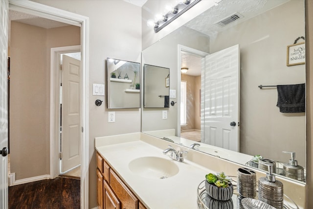 bathroom featuring vanity and hardwood / wood-style flooring