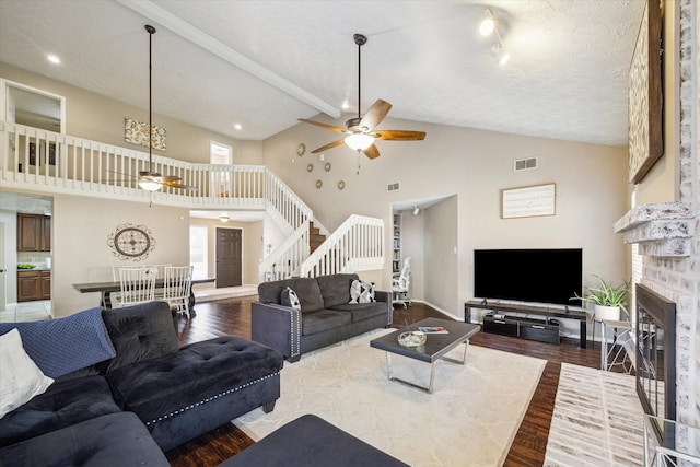 living room featuring hardwood / wood-style flooring, high vaulted ceiling, and ceiling fan