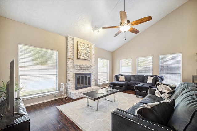 living room with hardwood / wood-style floors, high vaulted ceiling, a fireplace, and ceiling fan