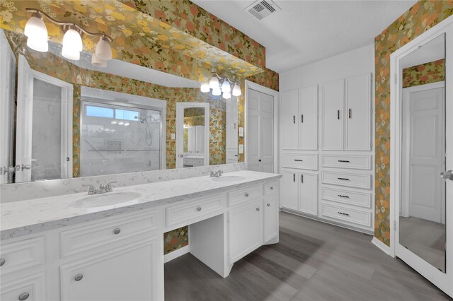 bathroom featuring vanity, hardwood / wood-style floors, and a shower