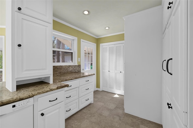 kitchen with white cabinetry, crown molding, dishwasher, and dark stone counters