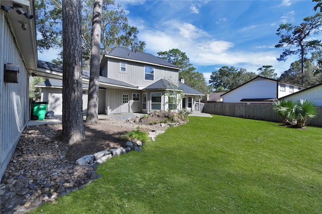 rear view of house featuring a lawn