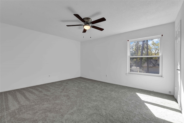 carpeted spare room with ceiling fan and a textured ceiling