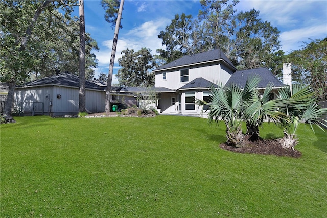 rear view of house with a lawn