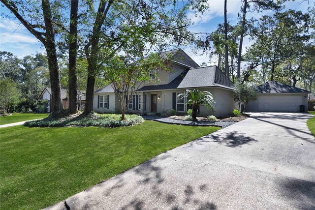 view of front of home with a front lawn and a garage