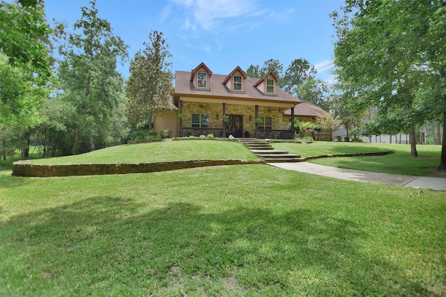 new england style home with a porch and a front lawn