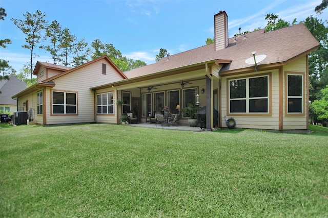 back of property with a patio, ceiling fan, a lawn, and central AC unit