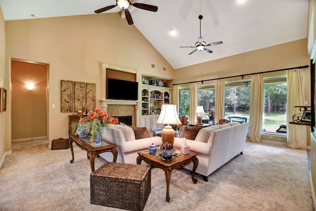 carpeted living room featuring ceiling fan and high vaulted ceiling