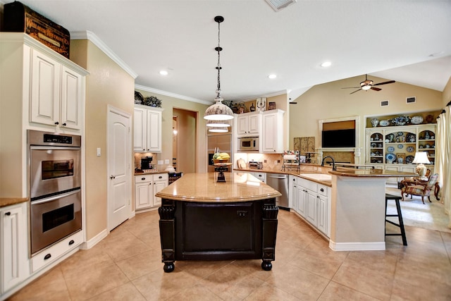 kitchen with a kitchen island, a breakfast bar area, kitchen peninsula, vaulted ceiling, and pendant lighting