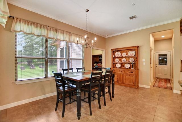 dining area featuring ornamental molding, light tile patterned floors, and a chandelier