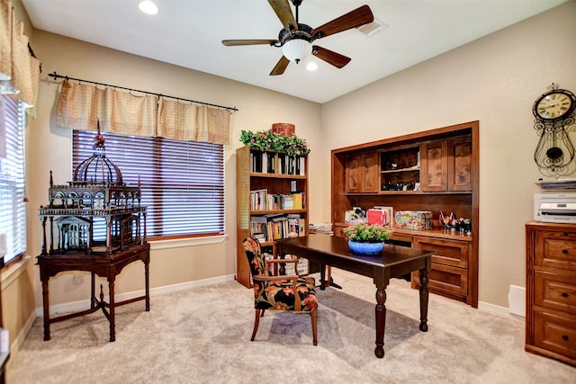 office space with light carpet and ceiling fan