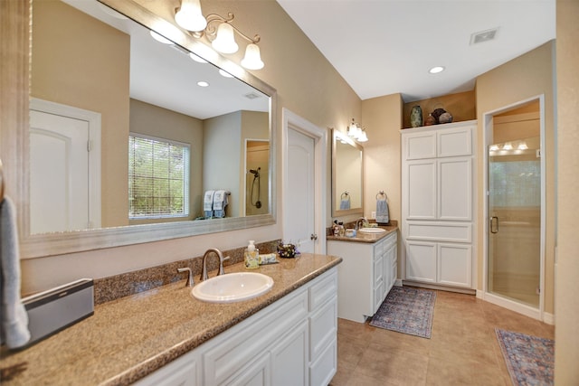 bathroom with vanity, tile patterned floors, and a shower with door