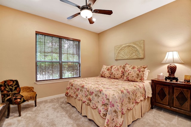 bedroom with ceiling fan and light colored carpet