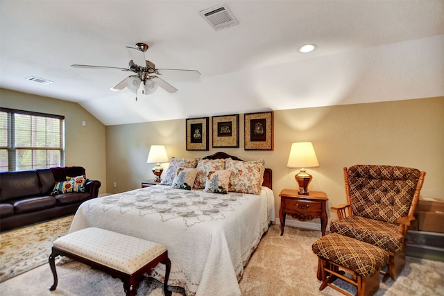 bedroom with vaulted ceiling, light colored carpet, and ceiling fan