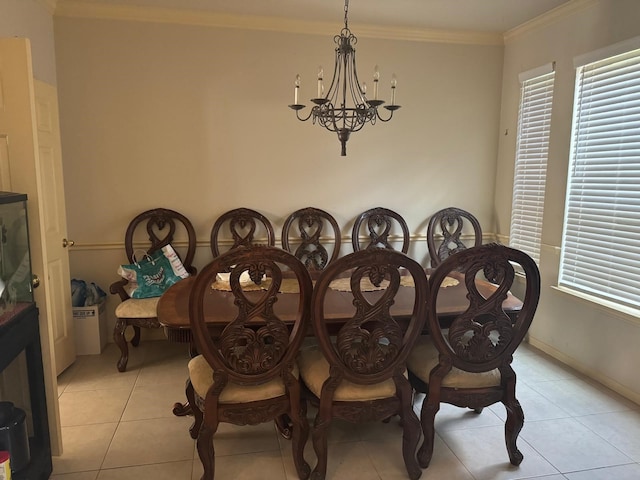 dining area with a chandelier, light tile patterned floors, and crown molding