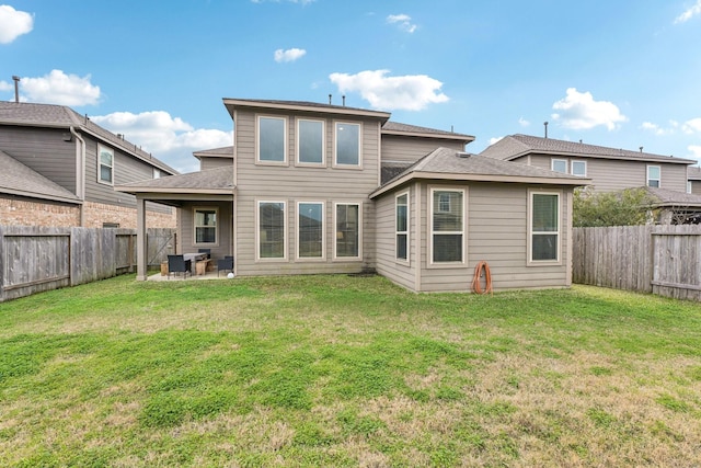 back of property with a lawn and a patio